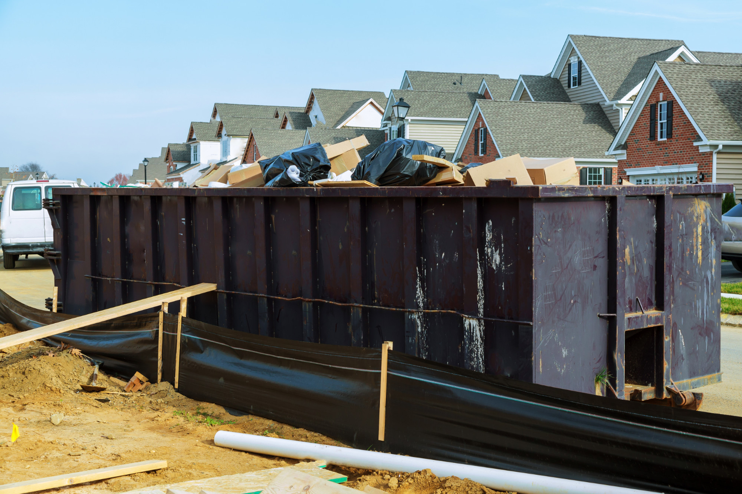 Large dumpster rental for cleanout projects and junk removal in a residential neighborhood.
