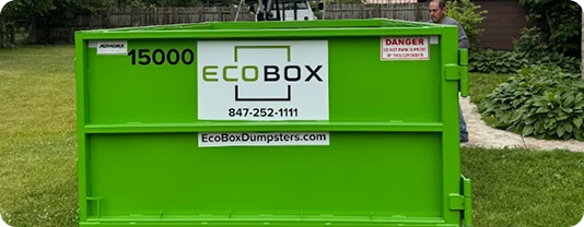 Side view of a large steel 15-yard EcoBox dumpster, suitable for home cleanouts and outdoor projects