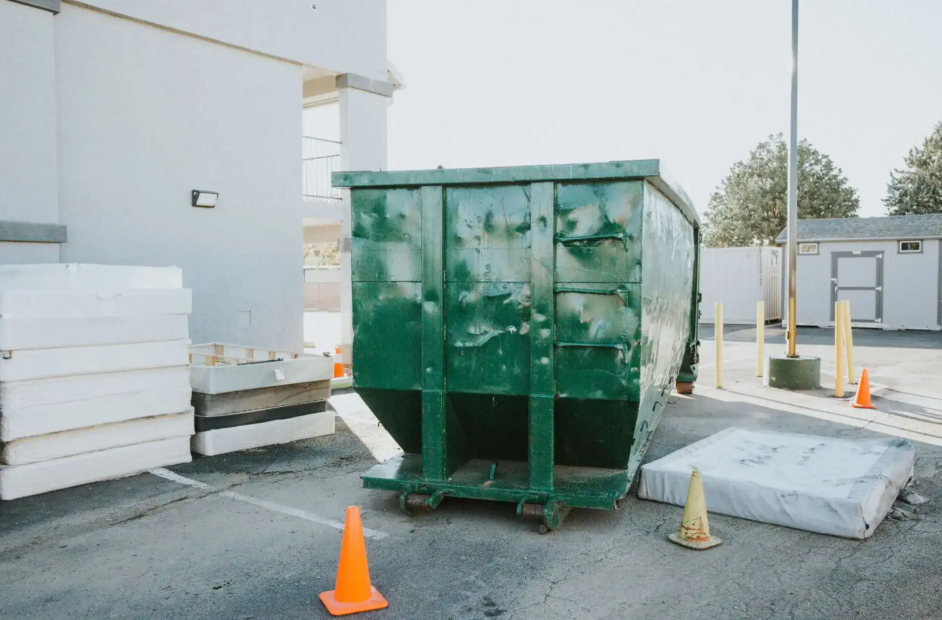 Green dumpster for debris removal during condo or apartment remodel.
