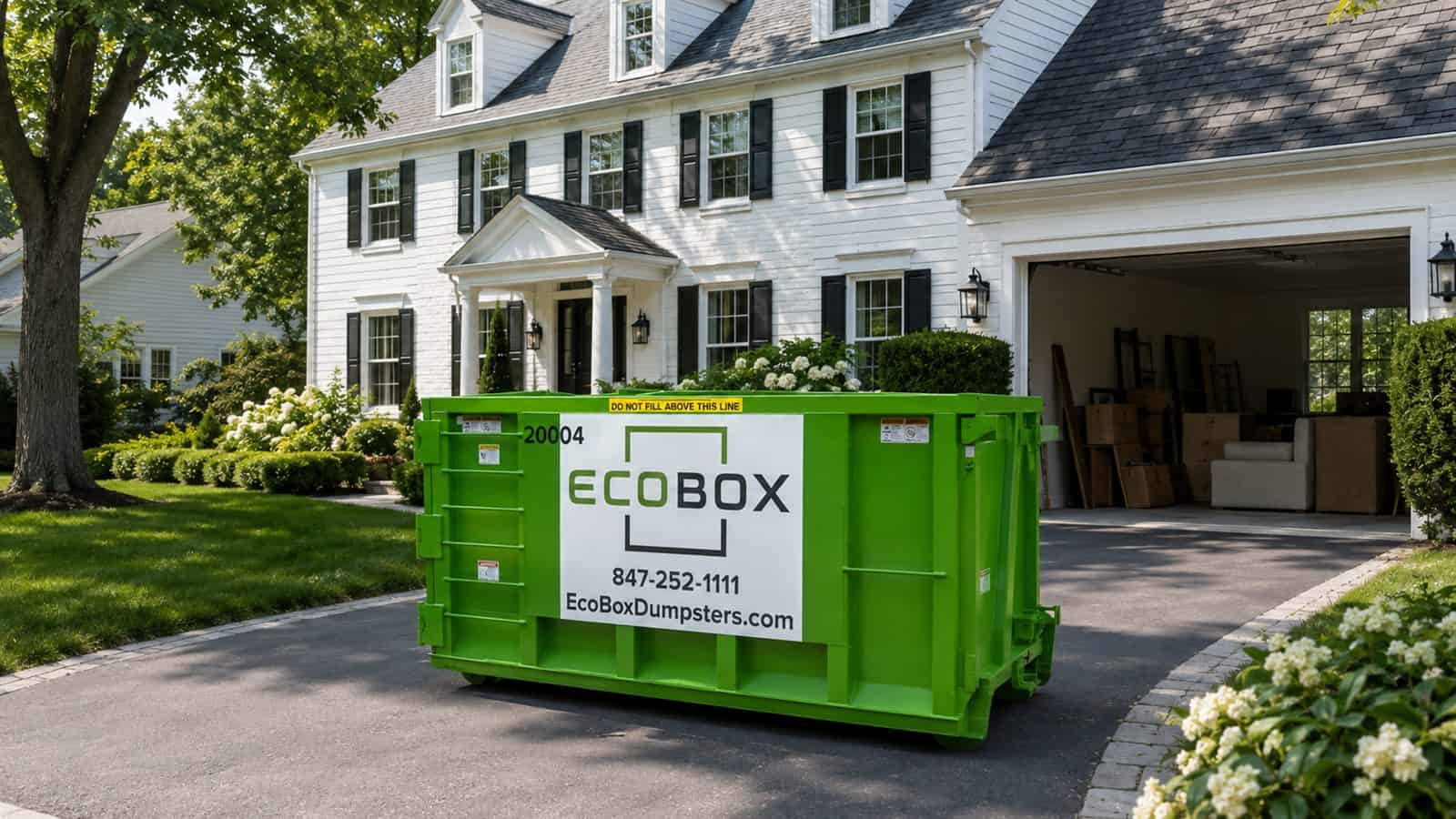 Green EcoBox dumpster on the driveway of a colonial home during a cleanout