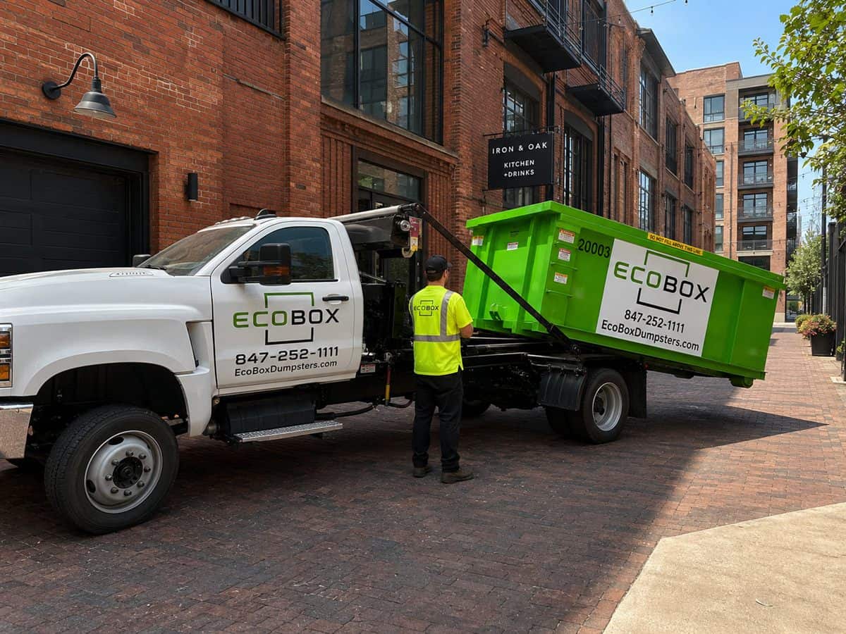 A roll-off dumpster outside a commercial building during a renovation