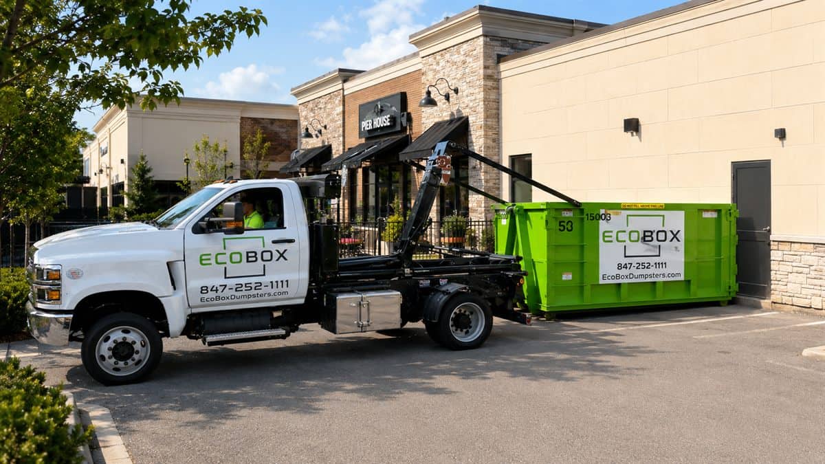 A roll-off dumpster outside a commercial building during a renovation