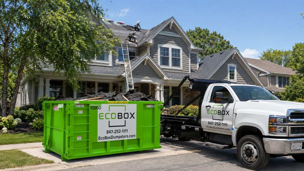 A roll-off dumpster parked on a residential driveway