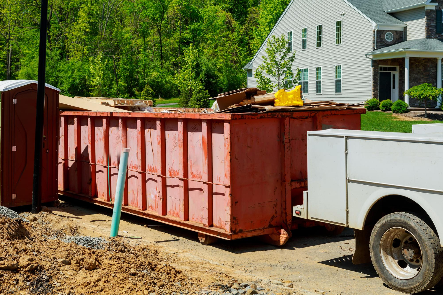 EcoBox dumpster in a residential area, filled with debris and recycling materials, promoting eco-friendly cleanup practices in Northeastern Illinois.